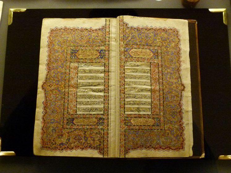 A Quran with geometric artwork in the margins of each page. 