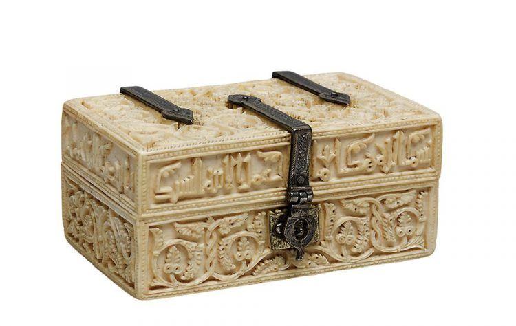 A small ivory box with intricate designs.