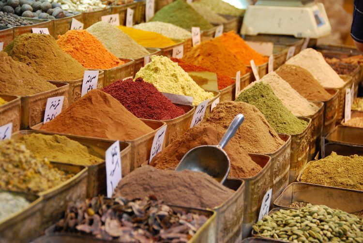 A picture of bins of spices in a market.